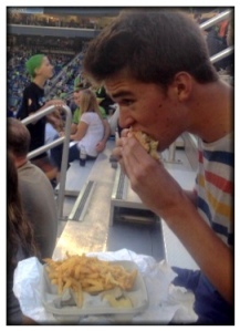 American Lesson #2 : At sporting event, eat hamburger with hands while balancing fries on lap.